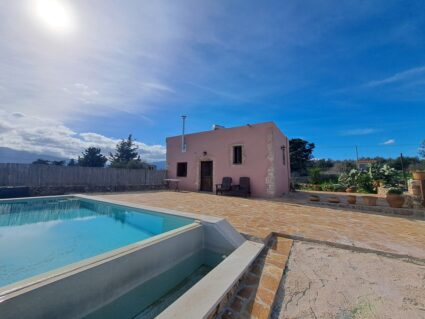 Private swimming pool and garden of a stone house for sale in Litsarda, Chania